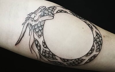Der Ouroboros als Tattoo auf dem Unterarm