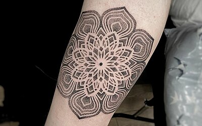 Mandala in dotwork style on the forearm 